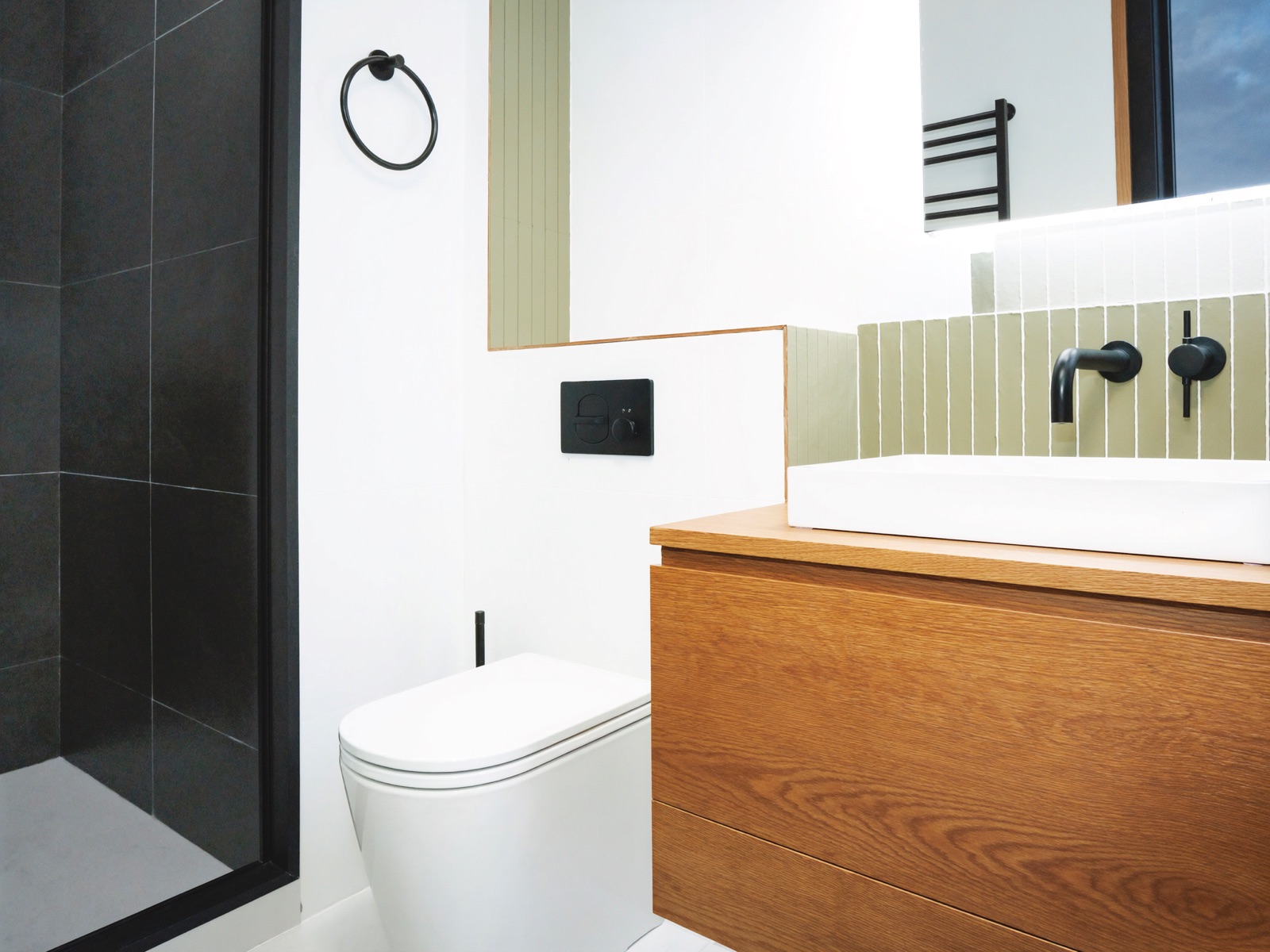 Compact renovated bathroom with matte black tapware