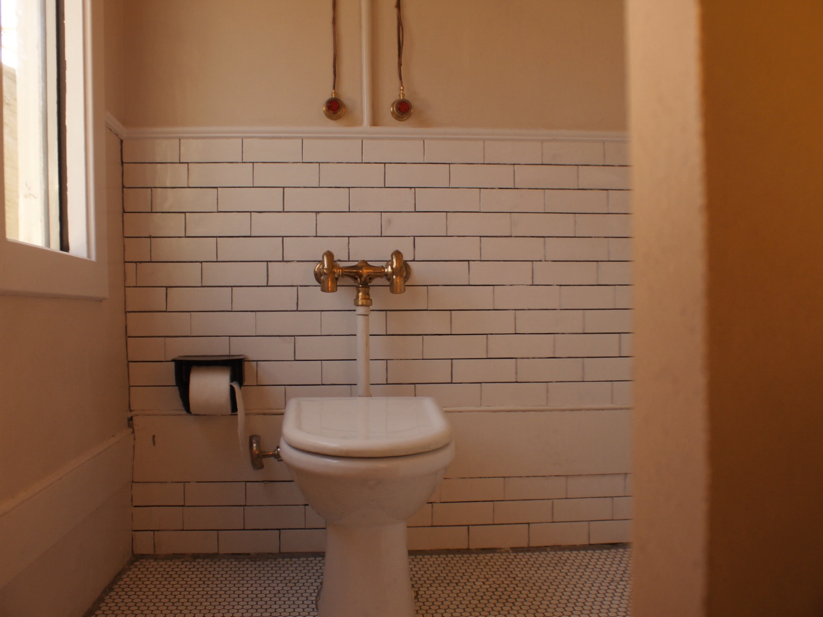 Classic renovated bathroom with charcoal grout subway tiles