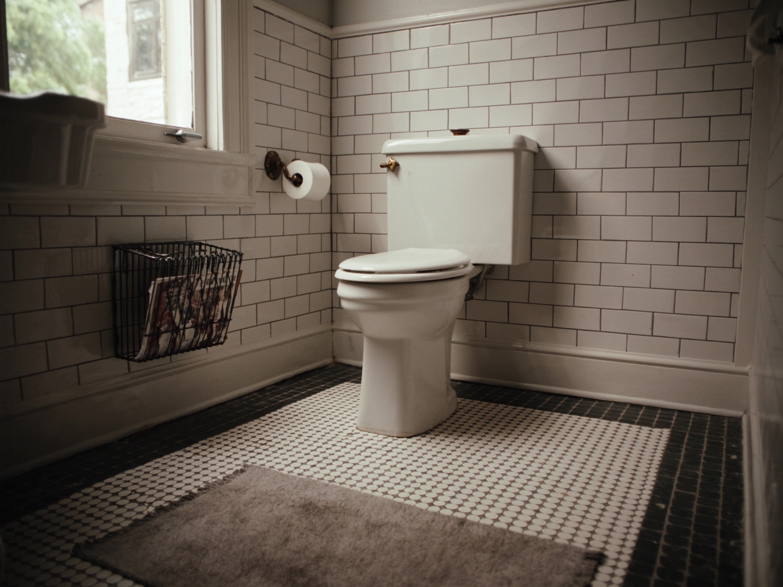 Renovated Federation-era bathroom with subway tiles and brass fittings