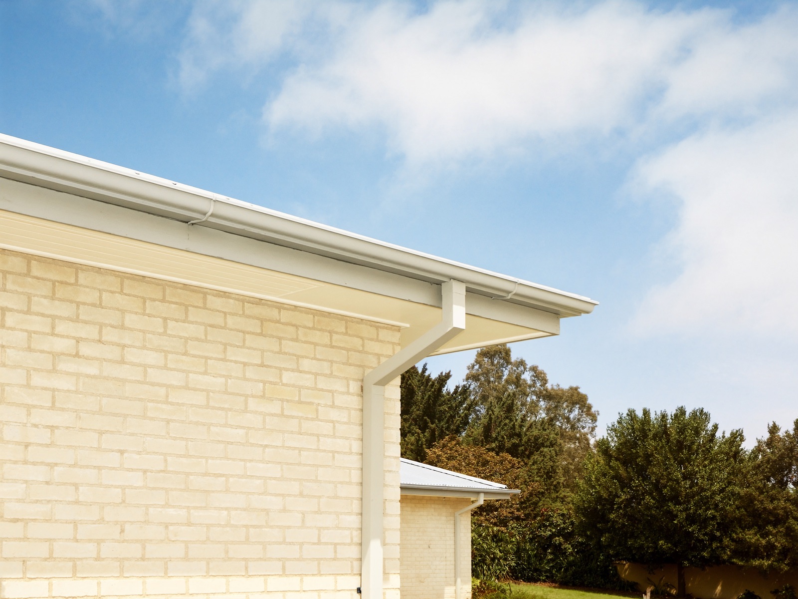 Clean roofline with freshly installed gutters and neat fascia